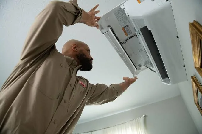 Technician servicing a ductless indoor comfort system for improved airflow